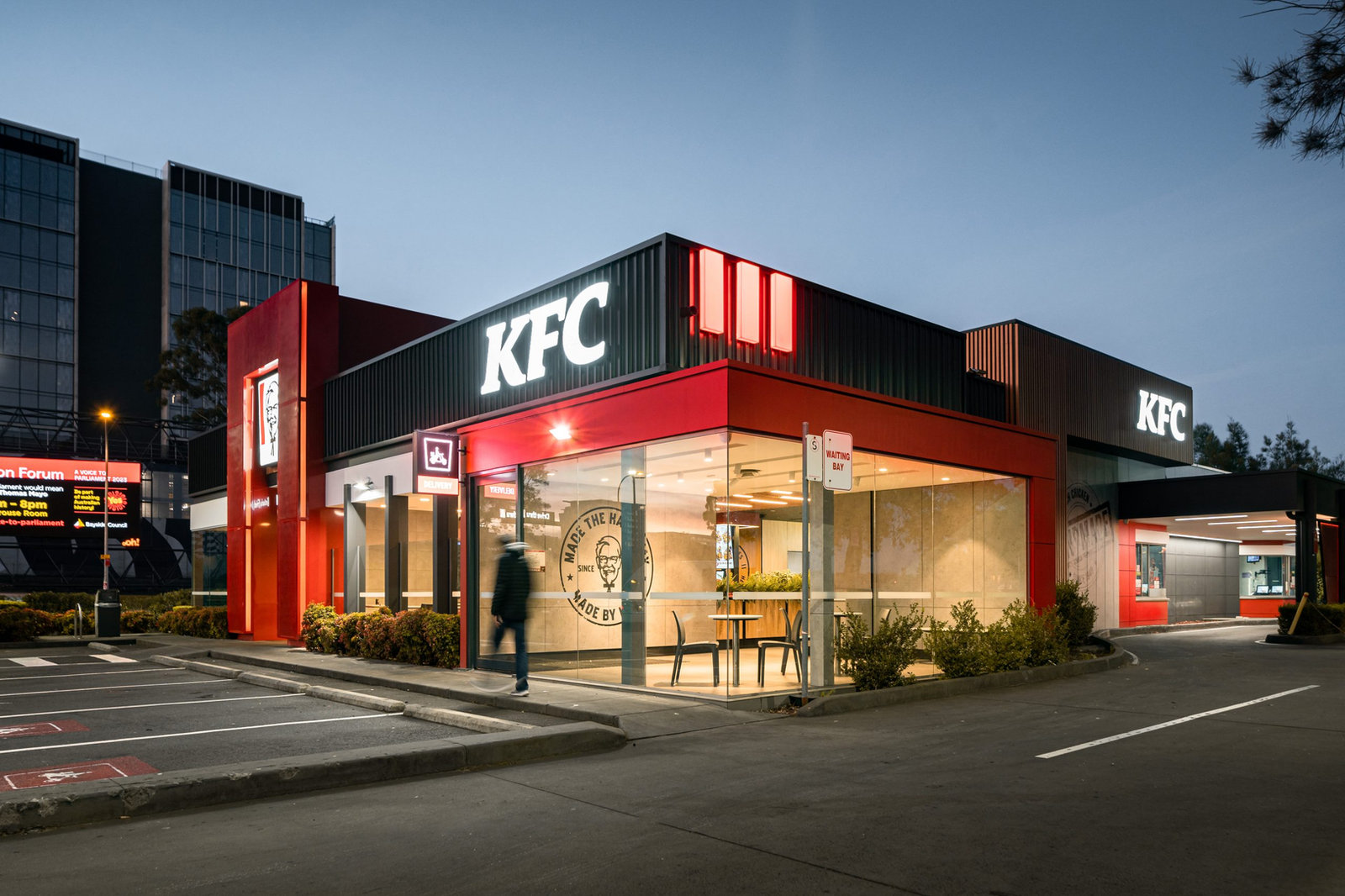 Quick-service restaurant exterior at dusk