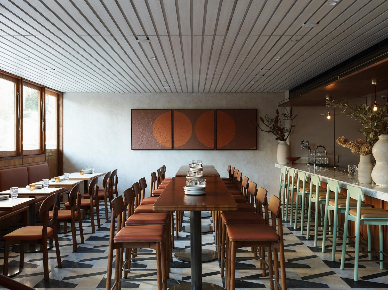 Restaurant dining room with leather seating and patterned stone floor